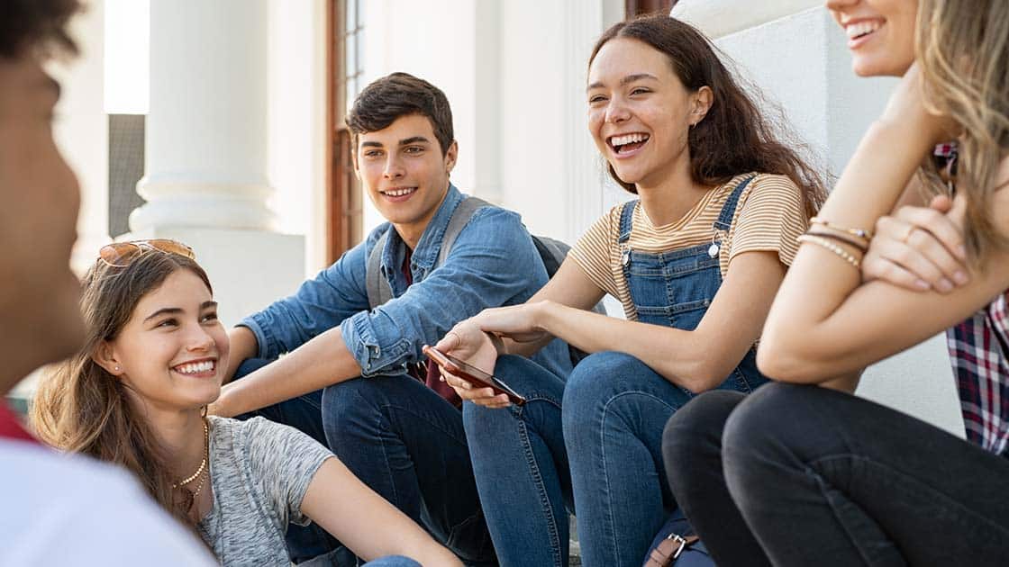 Teens sitting Outdoors